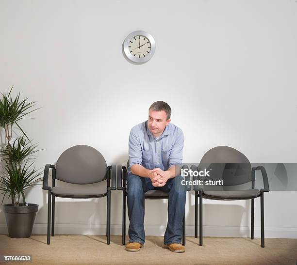 Man Sitting In A Waiting Room Stock Photo - Download Image Now - Waiting Room, Men, Sitting