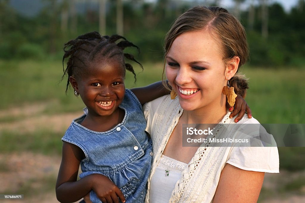 American Woman Holding African Girl  Adolescence Stock Photo