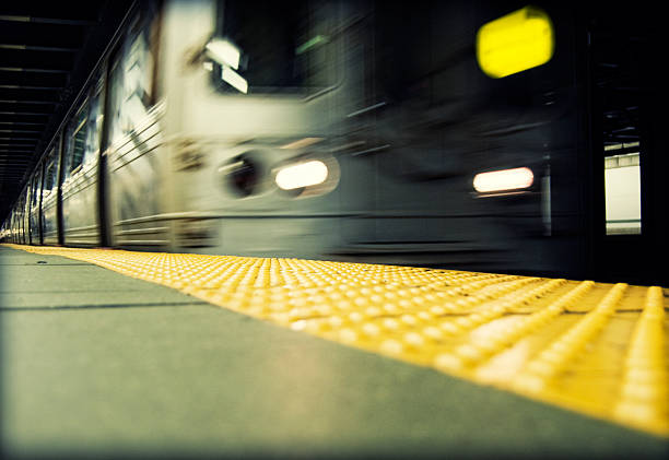A subway train with a green number on the door. The train is dark and the number is glowing