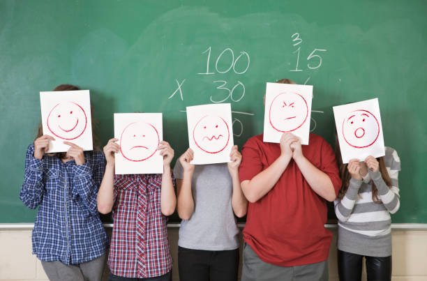Anonymous Students Five students holding faces of different emotions they have from worry to happy number 5 photos stock pictures, royalty-free photos & images
