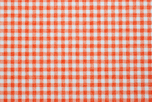 orange and white gingham pattern fabric