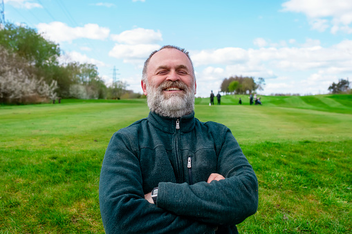 Confident, smiling man outdoors