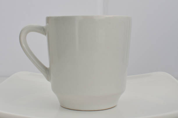 Porcelain of excellence: empty cup highlighted, placed on an impeccable white plate.