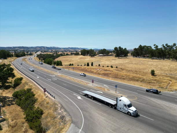 istock Rural Highway with Trucks and Car 1576914432