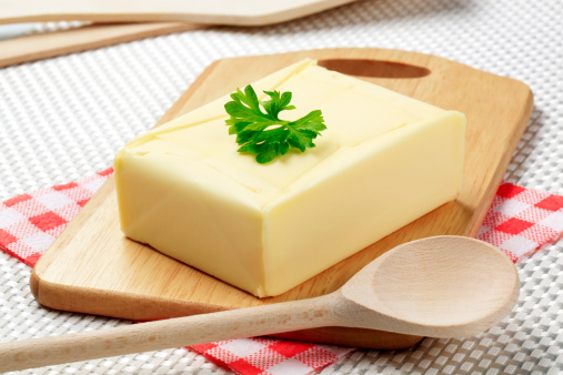 Block of fresh butter on a cutting board