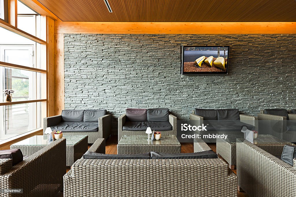 Luxury hotel lobby with tables, sofas and LCD TV Luxury hotel lobby with tables, sofas and LCD TV. Slovenia, Bohinjska bistrica. Television Set Stock Photo