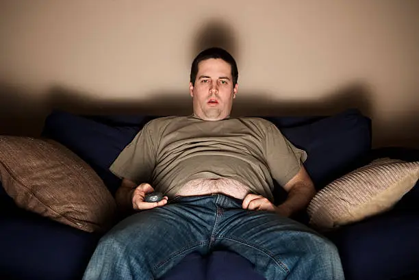 Photo of Overweight slob watching TV