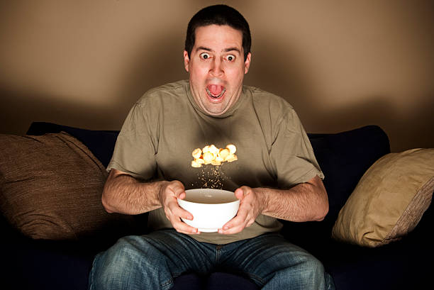 istock Man tosses his crisps in shock 157692161
