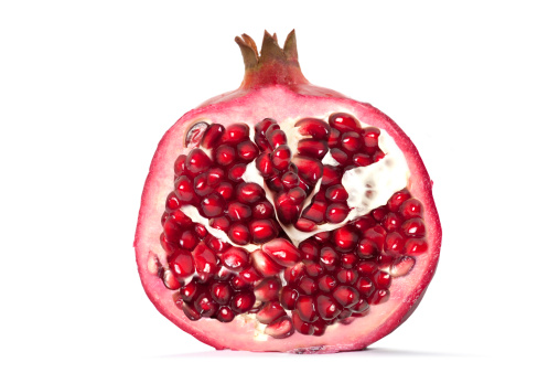 Fresh pomegranate isolated on a white background. Set or collection, sliced and whole, top view, close-up, isolated background.