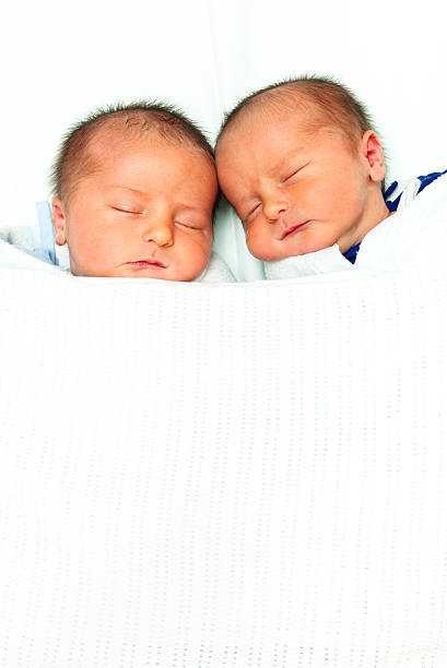 istock Identical twin boys sleep beside each other 157692437
