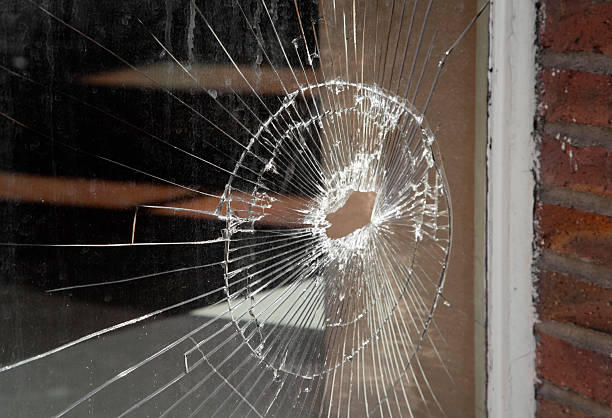 istock Shattered Glass In Storefront Window, Vandalism, Bullet Hole, Damage 157692445