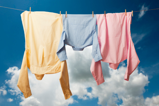 fresh laundry hanging on a clothesline in the blue sky.