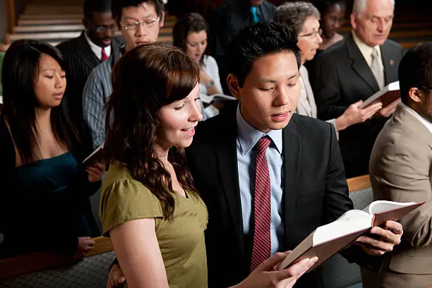 A diverse church congregation worshipping together 