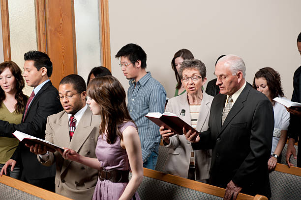 Church service A diverse church congregation worshipping together - Buy credits religious service photos stock pictures, royalty-free photos & images