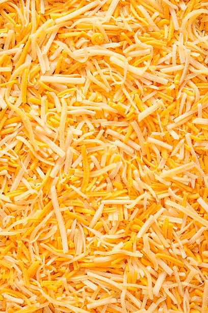 Mixed grated cheeses Top view of mix of grated parmesan an cheddar cheeses cheddar cheese stock pictures, royalty-free photos & images