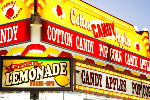 County fair carnival food concession stand sign with lemonade, cotton candy, and candy apples.
