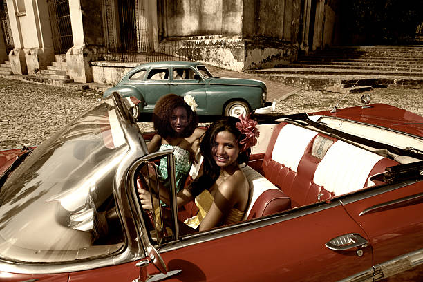 istock Two beautiful women posing with a red car 157693897