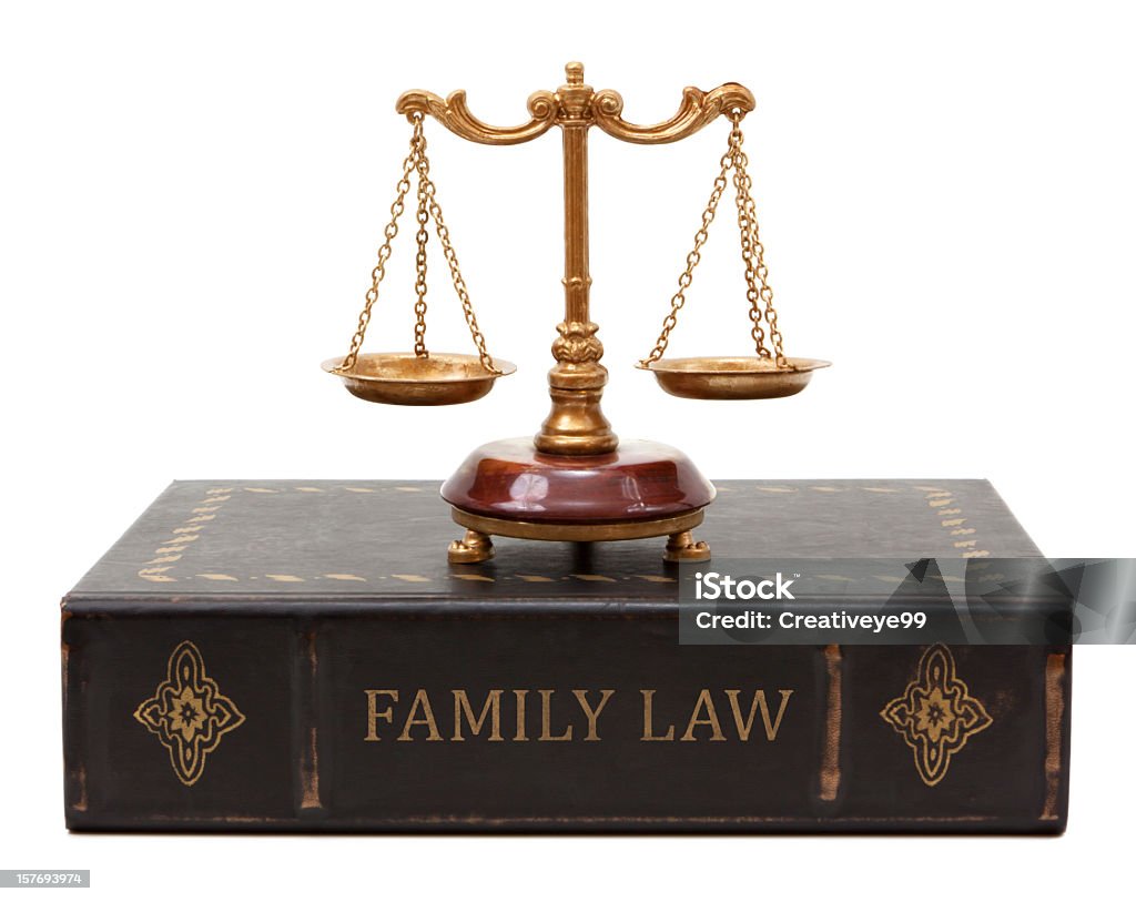 Family Law Family law book with scales of justice. The book spine is weathered and old looking. Lawyer Stock Photo
