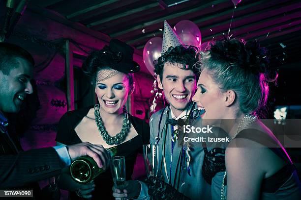 Smiling People Enjoying A Festive New Years Eve Stock Photo - Download Image Now - Champagne, Adult, Adults Only
