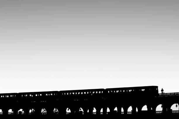 Shadows on pedestrian bridge.\nKansas City, Missouri, USA