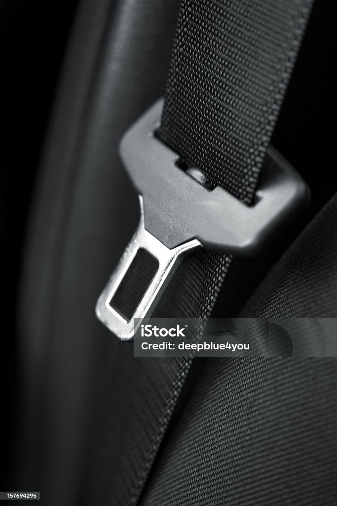 Black belt - vertikal close up close up pf a safety belt on black background Seat Belt Stock Photo