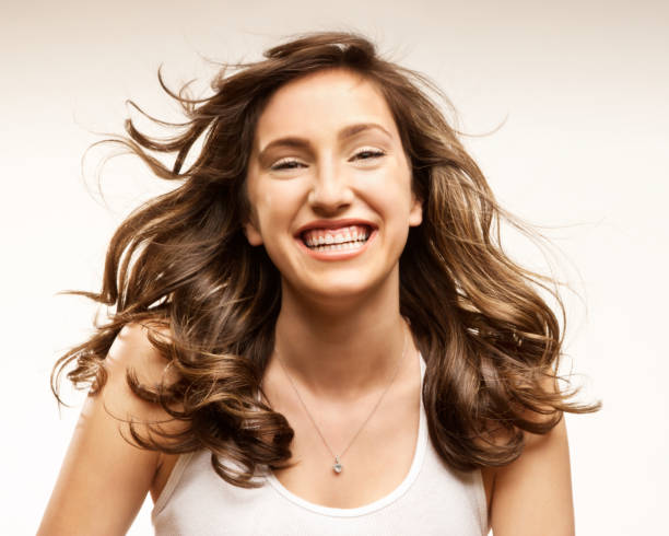 istock Attractive Young Woman Smiles. Windswept Hair. Horizontal Format. 157694304