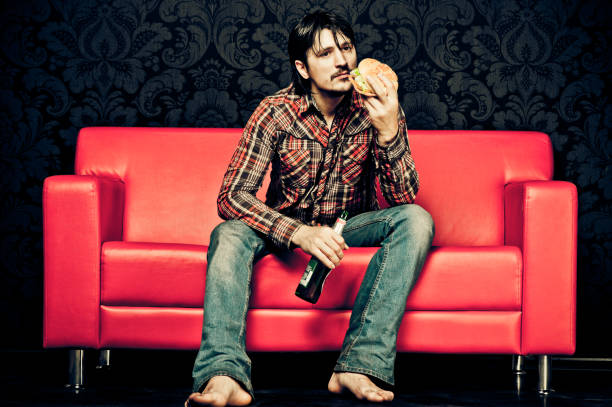 istock Sad man eating fast-food at home 157694393
