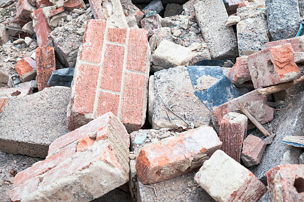 Discarded Building Rubble Bricks, stone and concrete blocks scattered in a pile on the ground at a demolishion site. rubble photos stock pictures, royalty-free photos & images