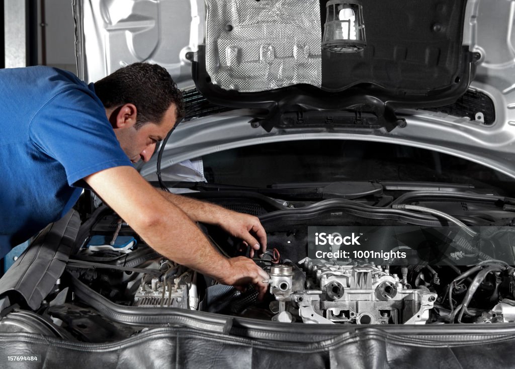 Auto Repair Shop Repairman working on a car Adult Stock Photo