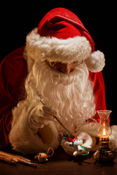 istock Santa Claus painting a toy 157694539
