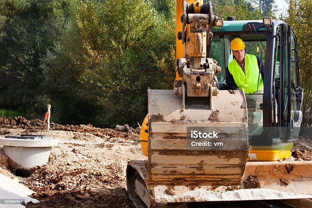 Excavator Driver on a Construction Site  Backhoe Stock Photo