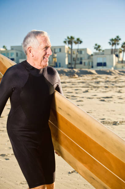 istock senior surfer close up with surfboard 157694978