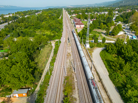 Aerial view of train ride by green trees and lake