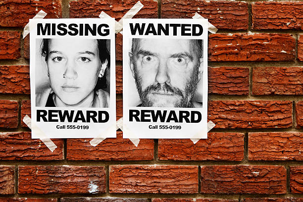 istock Missing and Wanted posters taped to brick wall 157695488