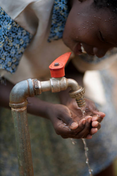 istock African girl is drinking from a tab 157695798