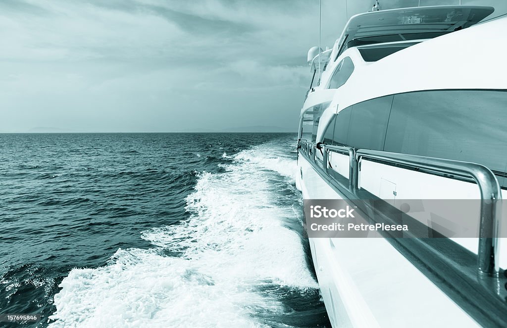 Luxury yacht sailing at sea. Blue toned image.  Desaturated Stock Photo