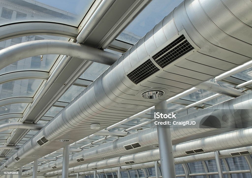 Metal ducting on the ceiling of a building  Commercial air conditioning equipment and lighting equipment Air Duct Stock Photo