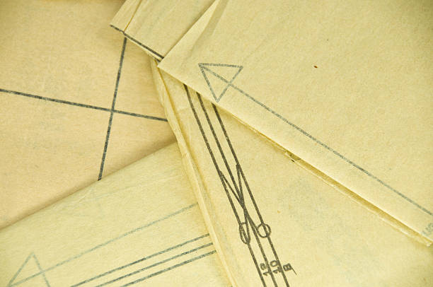 Sewing Pattern Background A section of an old paper sewing pattern ... background with copy space. clothing pattern stock pictures, royalty-free photos & images