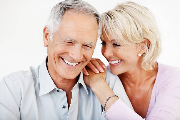 An attractive mature couple spending time together Closeup portrait of an attractive mature couple spending time together women beautiful studio shot isolated on white stock pictures, royalty-free photos & images