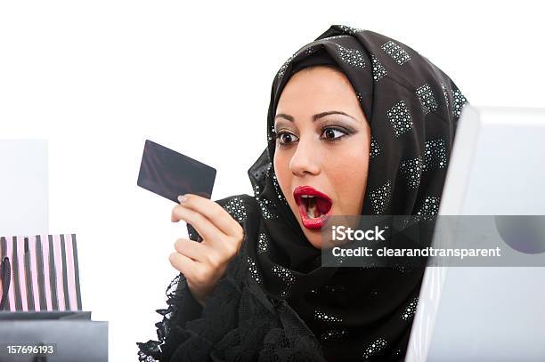 Shocked Arabic Girl Shopping On The Internet Stock Photo - Download Image Now - Kuwait, Senior Adult, Arabia