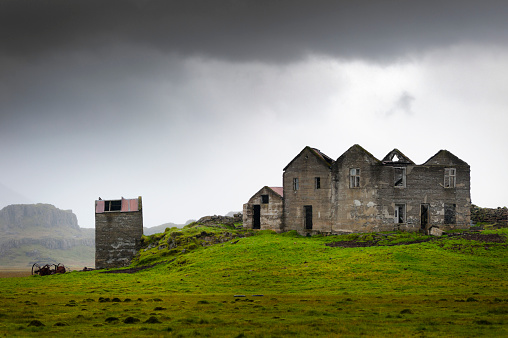 abandoned and derelict  farmhouse on iceland, dramatic dark sky