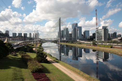 View of Octavio Frias de Oliveira Bridge and Sao Paulo city skyline. The Octavio Frias de Oliveira bridge is a cable-stayed bridge in São Paulo, Brazil over the Pinheiros River.