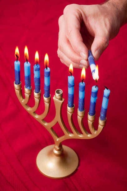 menorah in rosso - hanukkah menorah human hand lighting equipment foto e immagini stock