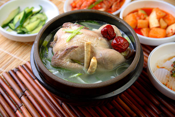 Samgyetang Samgyetang, Korean soup, which primarily consists of a whole young chicken and Korean ginseng. "Ginseng chicken soup" in English. Samgyetang is traditionally served in the summer for its supposed nutrients, which replaces those lost through excessive sweating and physical exertion during the hot summers in Korea. chicken soup stock pictures, royalty-free photos & images