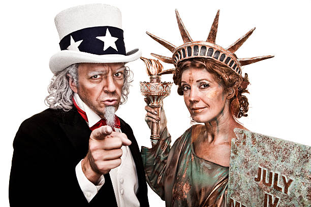 Two people dressed as Uncle Sam and Lady Liberty A stock photo of Uncle Sam with Lady Liberty against a white background with the iconic "I WANT YOU" pointing pose. i want you stock pictures, royalty-free photos & images