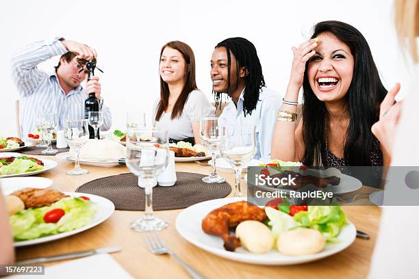 Happy Young People Gathered Round Dining Table Stock Photo - Download Image Now - 20-29 Years, Adult, Adults Only