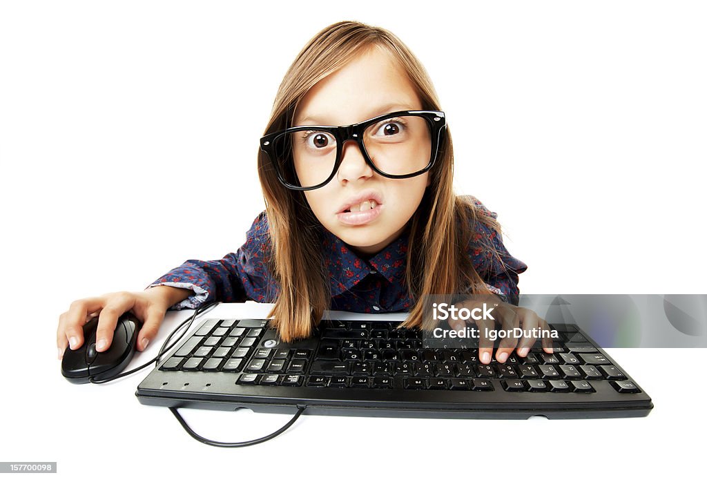 Girl working on a computer Young girl working or playing with computer, isolated on white Bad News Stock Photo