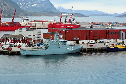 Nuuk / Godthåb, Sermersooq, Greenland: HDMS Knud Rasmussen (P570) Royal Danish Navy patrol vessel moored in the harbor, Naalagaast street, pier 48 - The ship is named after the Danish/Greenlandic polar researcher Knud Rasmussen, who undertook several expeditions in Greenland. The ship was built at Karstensen Shipyard, where it was designated as hull number 400. It is designed to break through ice sheets up tp 80cm thick. View of the fjords in the background.