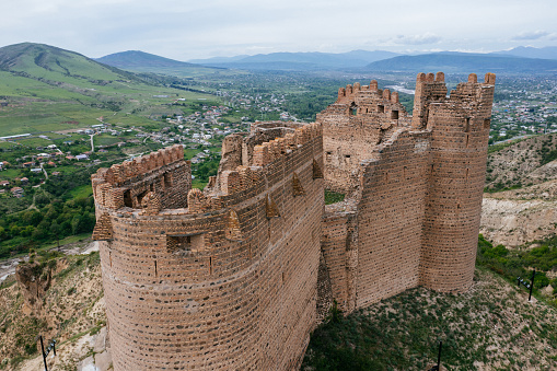 Ancient old fortress. Mukhrani Ksani Castle ruin in mountains, aerial drone view.