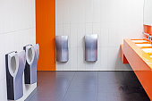 toilet with washbasins, hand dryers in a supermarket in light orange colors